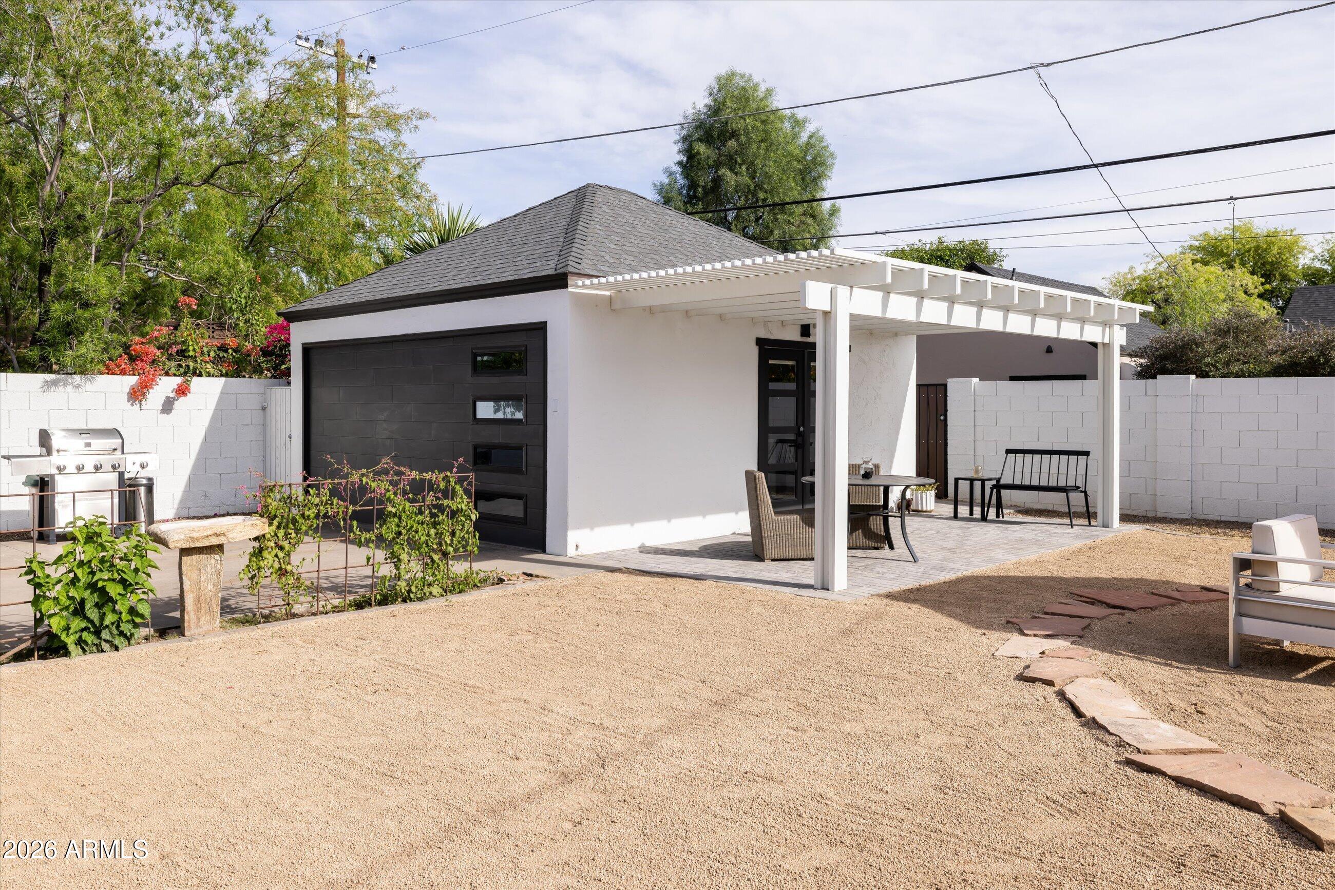 537 Virginia Avenue Phoenix, AZ 85003 - Photo 21 of 32 a front view of a house with a yard and potted plants