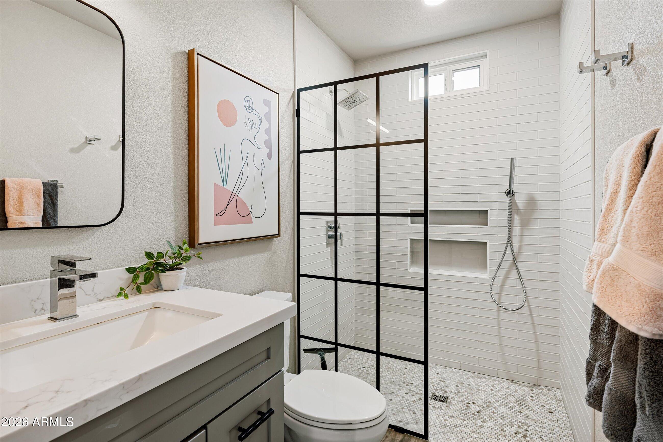 537 Virginia Avenue Phoenix, AZ 85003 - Photo 26 of 32 a bathroom with a sink toilet and shower