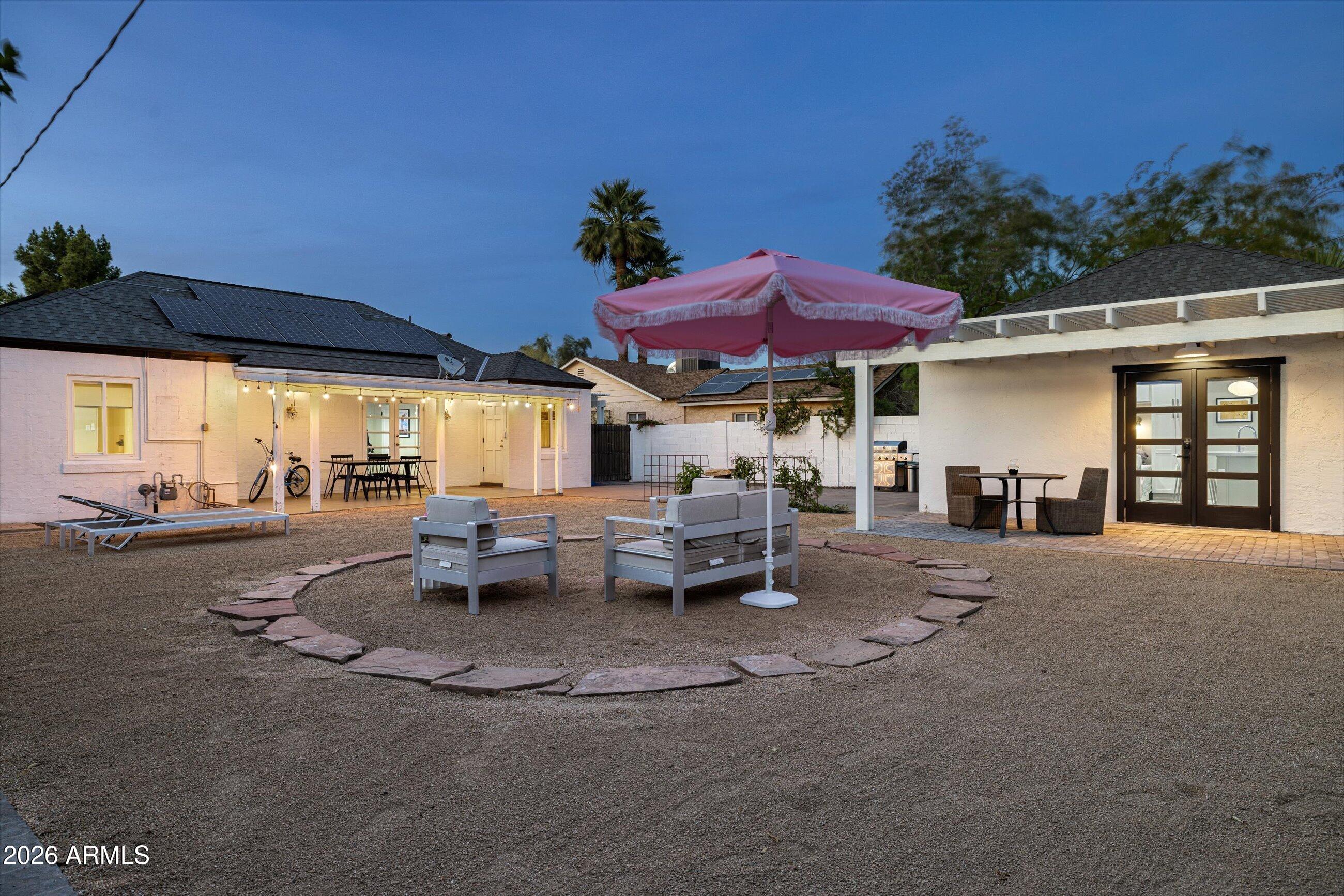 537 Virginia Avenue Phoenix, AZ 85003 - Photo 4 of 32 a view of a patio with table and chairs under an umbrella