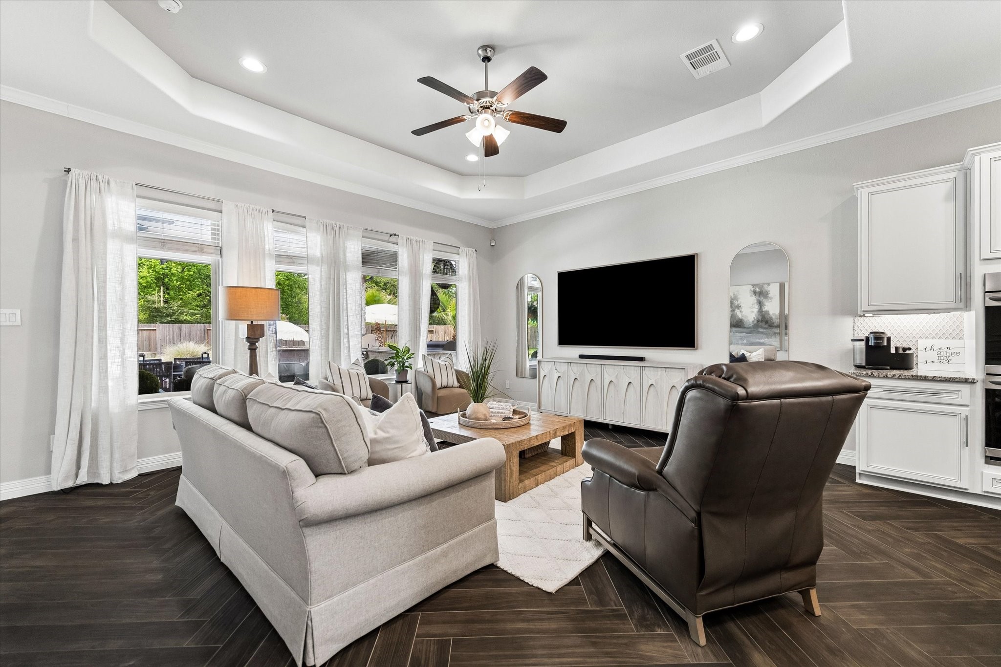 5935 Dovershire Knoll Court Spring, TX 77389 - Photo 13 of 34 a living room with furniture ceiling fan and a flat screen tv