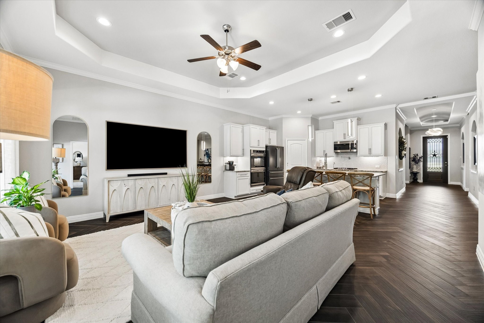 5935 Dovershire Knoll Court Spring, TX 77389 - Photo 14 of 34 a living room with furniture kitchen view and a flat screen tv