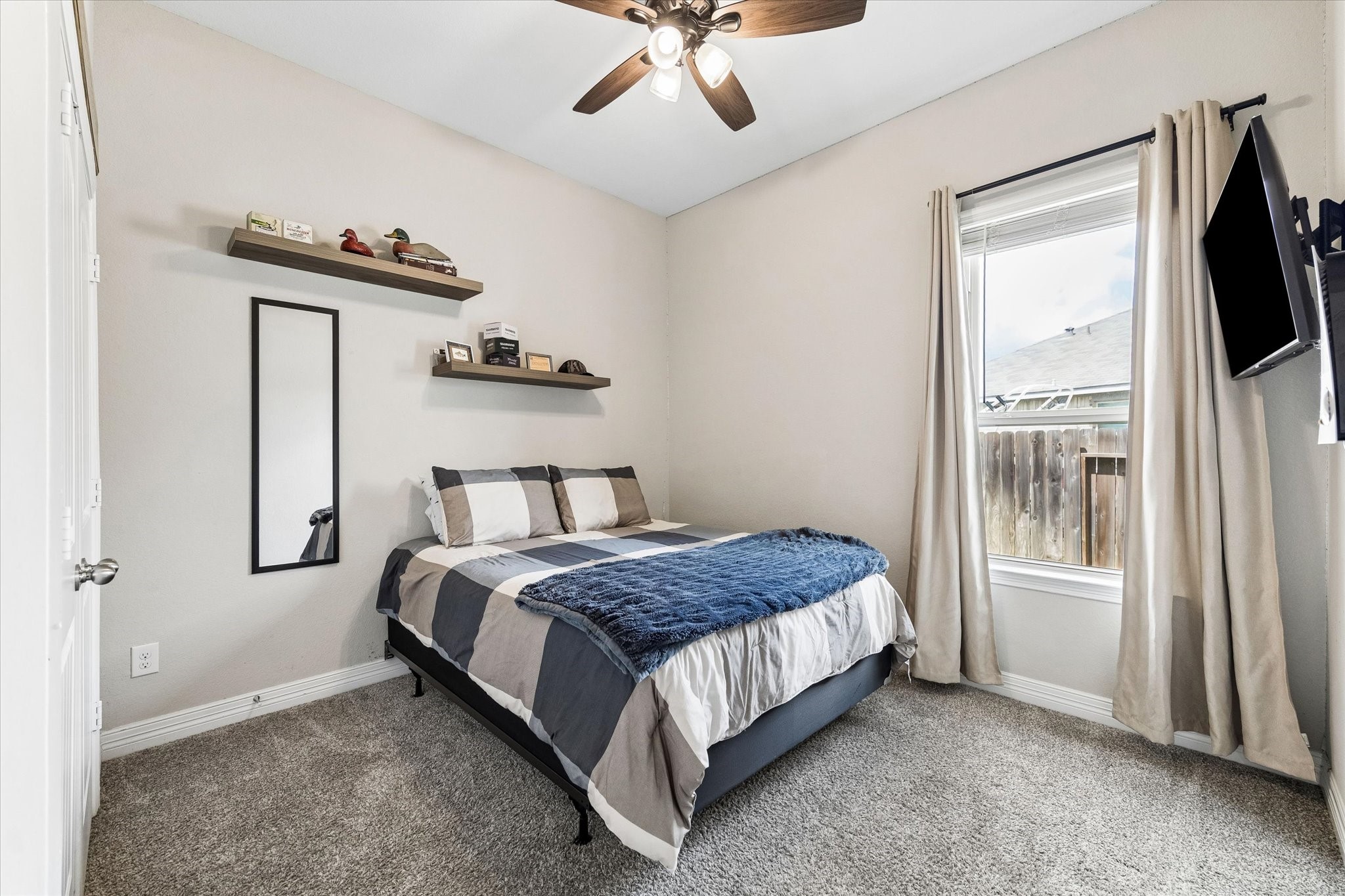 5935 Dovershire Knoll Court Spring, TX 77389 - Photo 19 of 34 a bedroom with a bed and a flat tv screen