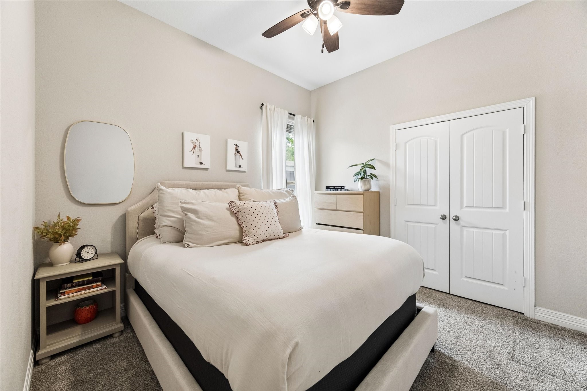 5935 Dovershire Knoll Court Spring, TX 77389 - Photo 20 of 34 a bedroom with a bed and a chandelier