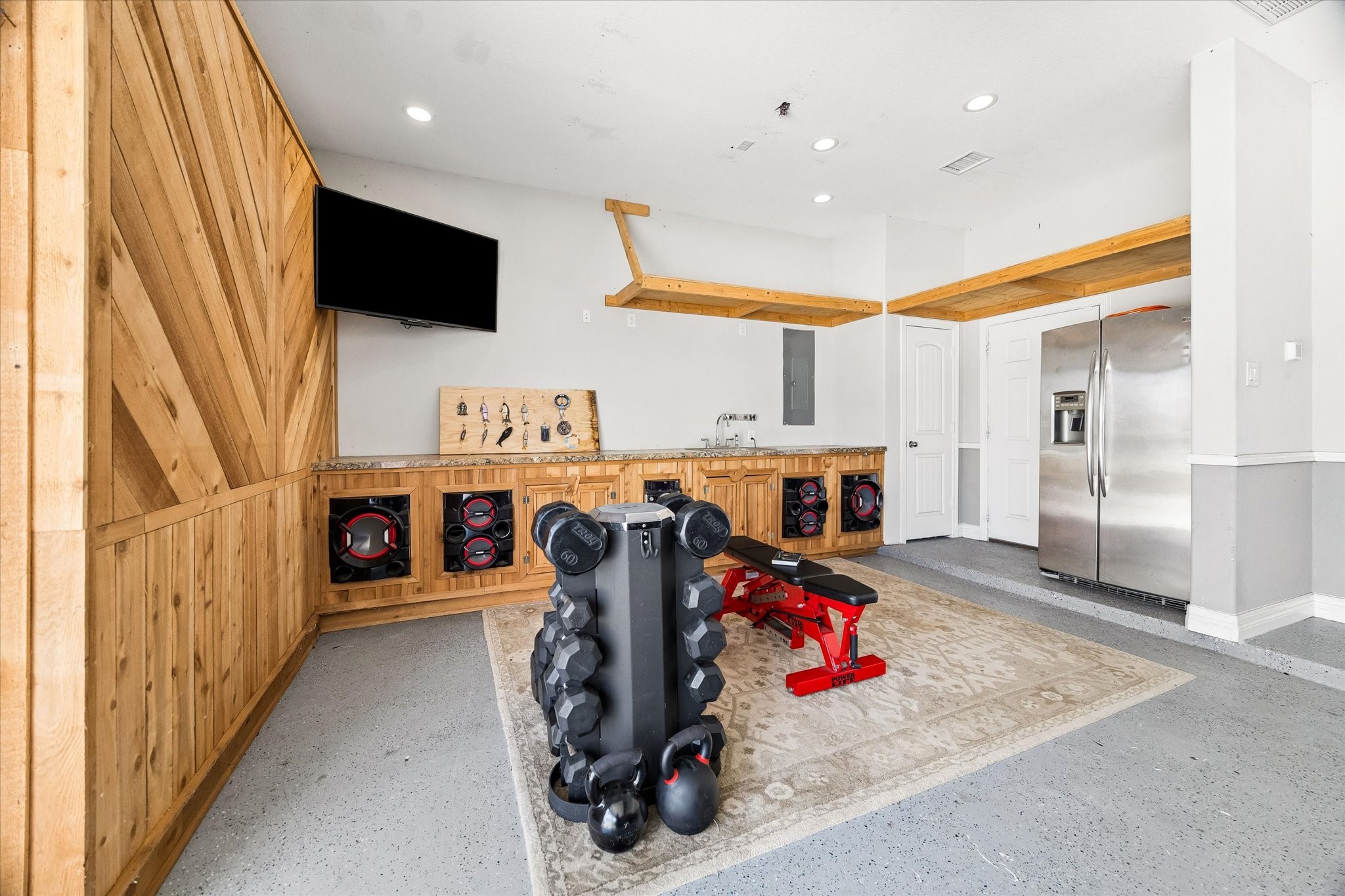 5935 Dovershire Knoll Court Spring, TX 77389 - Photo 25 of 34 a utility room with stainless steel appliances kitchen island granite countertop a refrigerator and a flat screen tv
