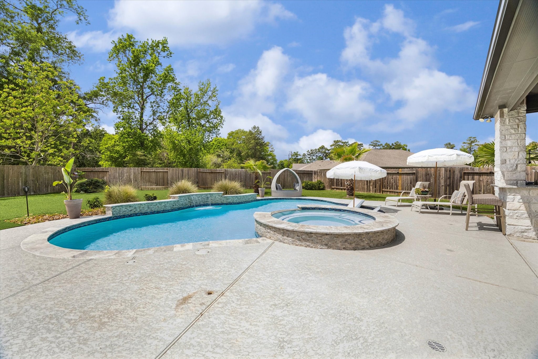 5935 Dovershire Knoll Court Spring, TX 77389 - Photo 30 of 34 a view of a swimming pool with a patio