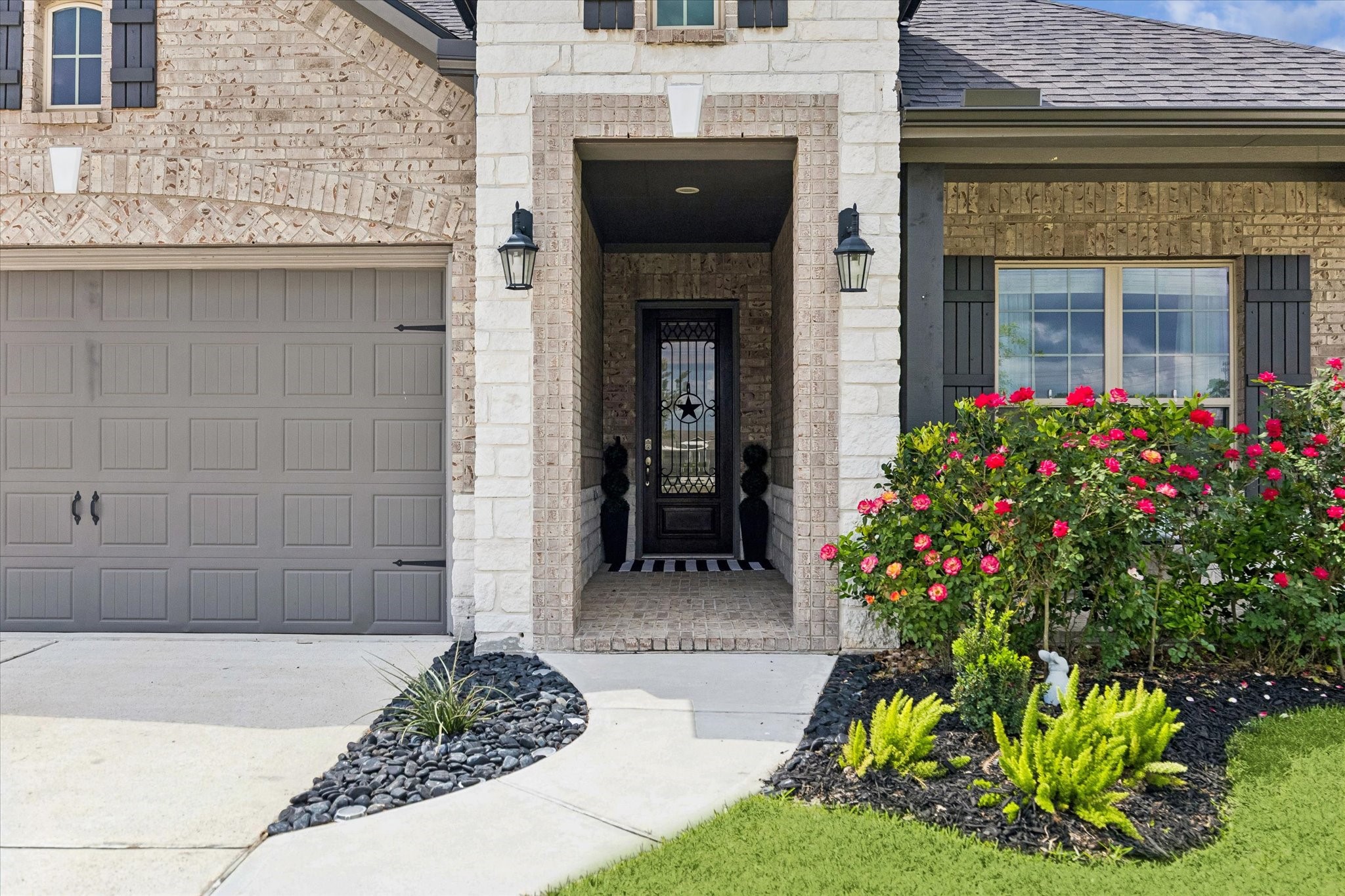 5935 Dovershire Knoll Court Spring, TX 77389 - Photo 4 of 34 a front view of a house with a garden
