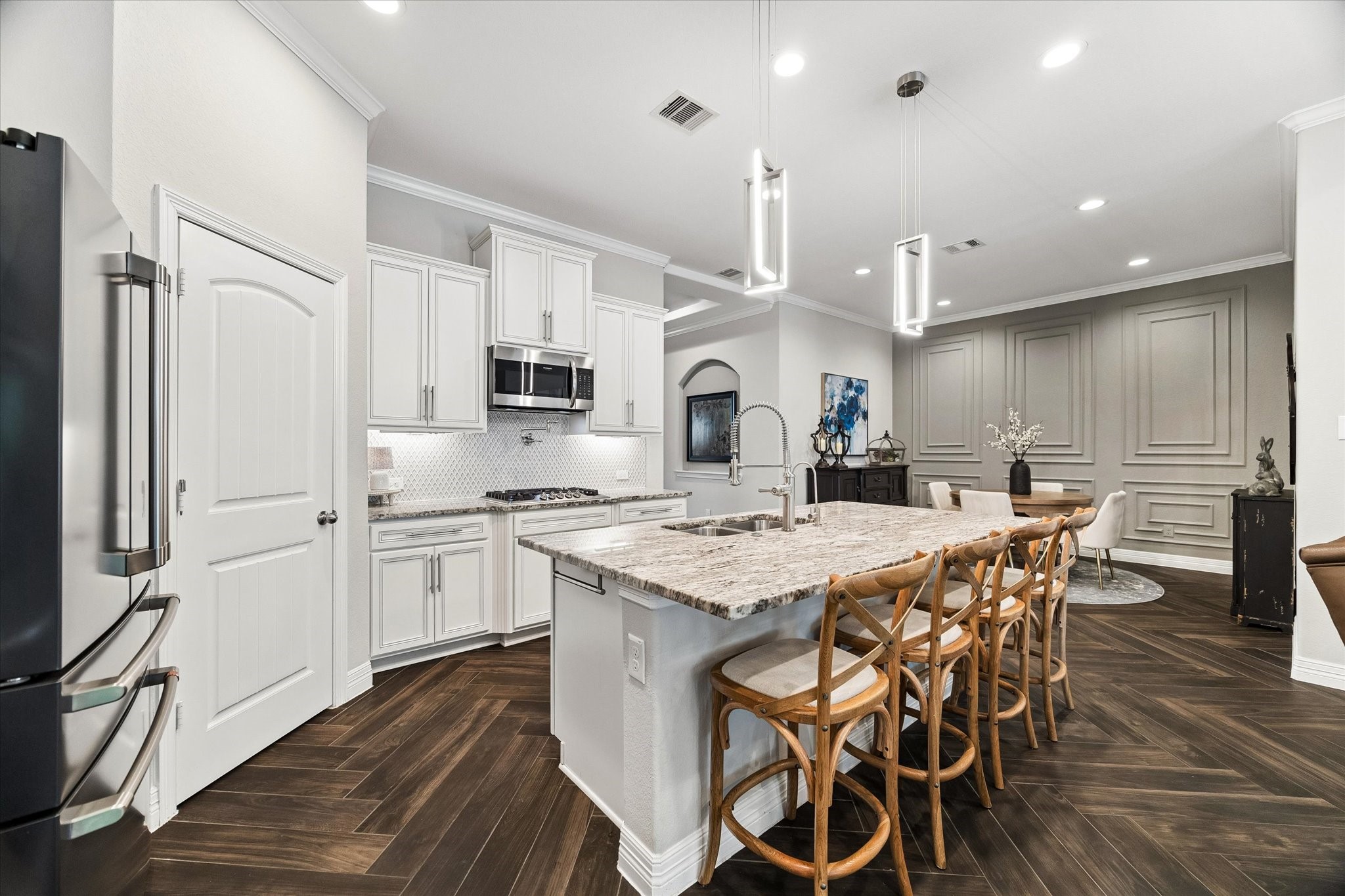 5935 Dovershire Knoll Court Spring, TX 77389 - Photo 10 of 34 a kitchen with stainless steel appliances kitchen island granite countertop a kitchen island a stove a table and chairs in it