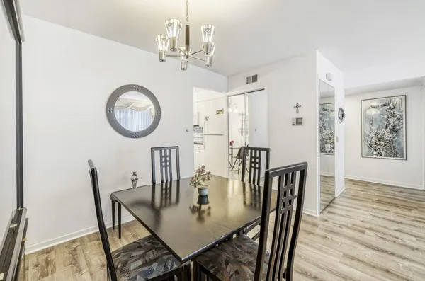 a view of a dining room with furniture and wooden floor