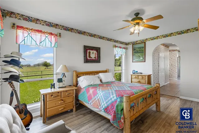 a bedroom with a bed and a chandelier