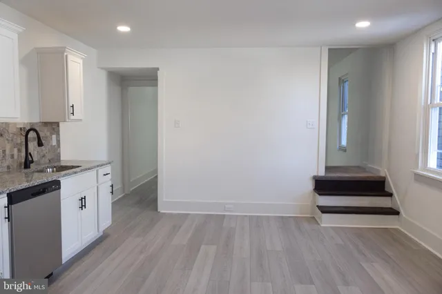 a kitchen with sink and cabinets