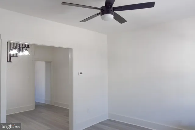 a view of an empty room with wooden floor