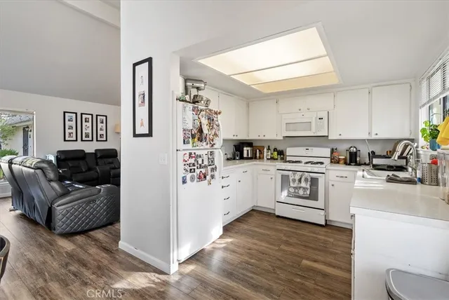 a view of a room with lots of furniture and white walls