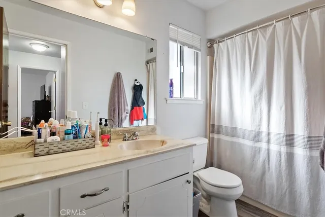 a living room with furniture and a book shelf