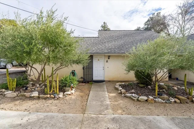 a view of a backyard with a tub and wooden fence