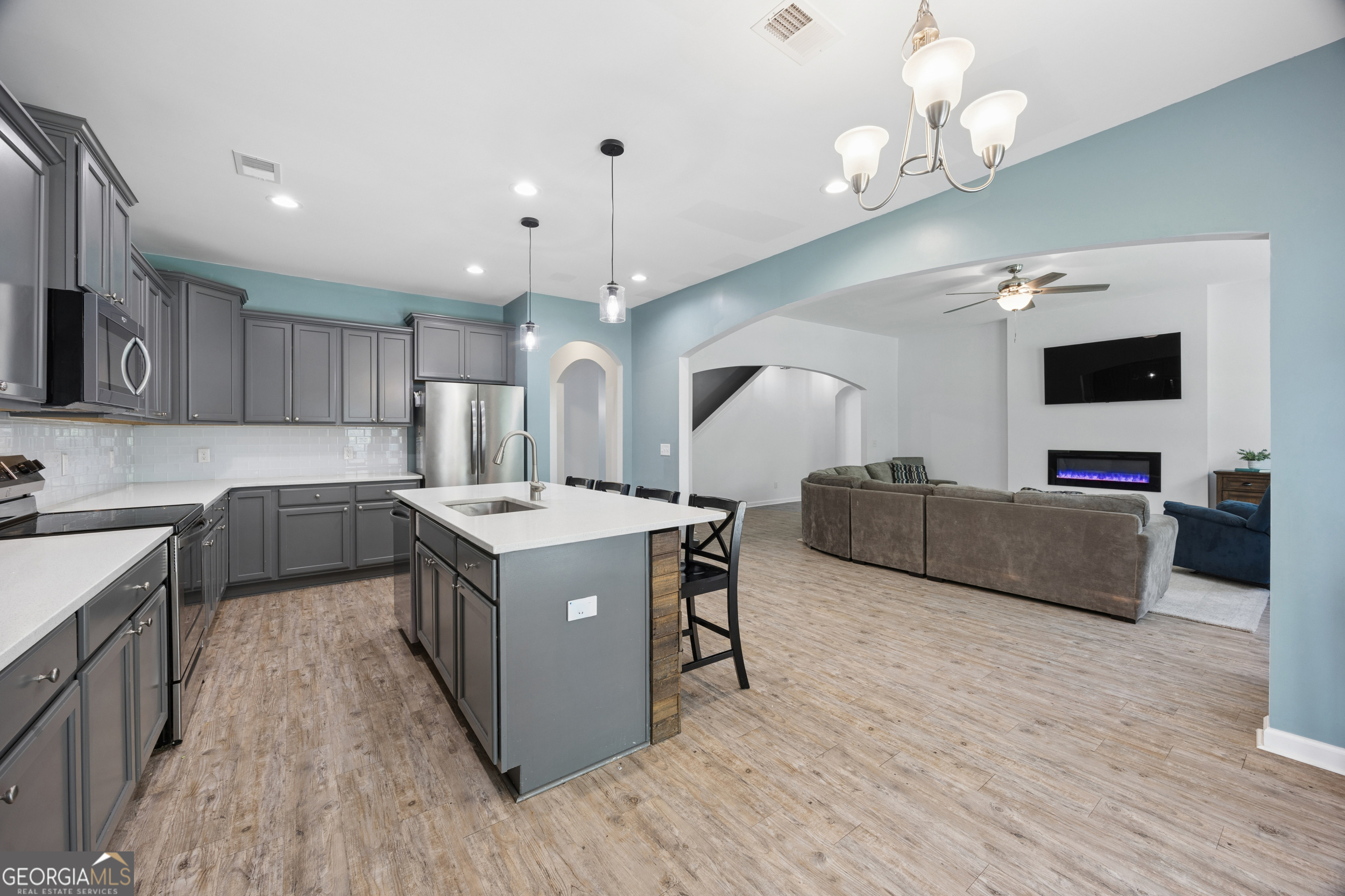 369 Waybridge Way Richmond Hill, GA 31324 - Photo 18 of 40 a kitchen with stove and wooden floor