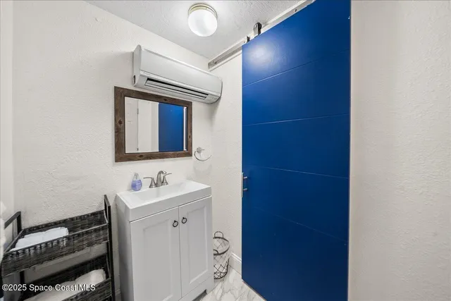 a bedroom with a bed and painting on the wall