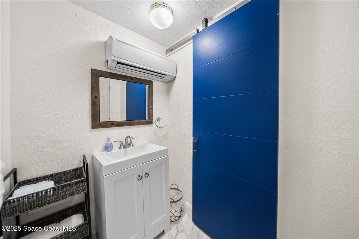 111 South Atlantic Avenue Cocoa Beach, FL 32931 - Photo 15 of 71 a bathroom with a sink and a mirror