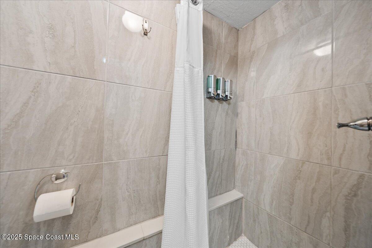 111 South Atlantic Avenue Cocoa Beach, FL 32931 - Photo 16 of 71 a bathroom with a shower