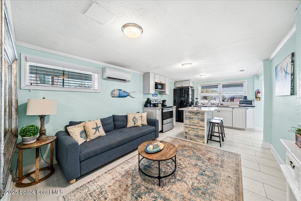 111 South Atlantic Avenue Cocoa Beach, FL 32931 - Photo 18 of 71 a living room with furniture and a view of kitchen