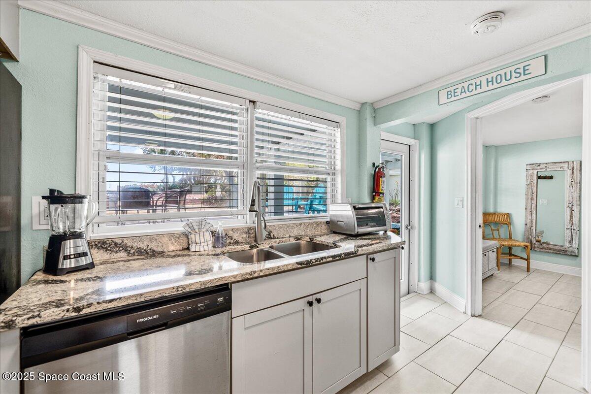 111 South Atlantic Avenue Cocoa Beach, FL 32931 - Photo 22 of 71 a kitchen with a sink and cabinets