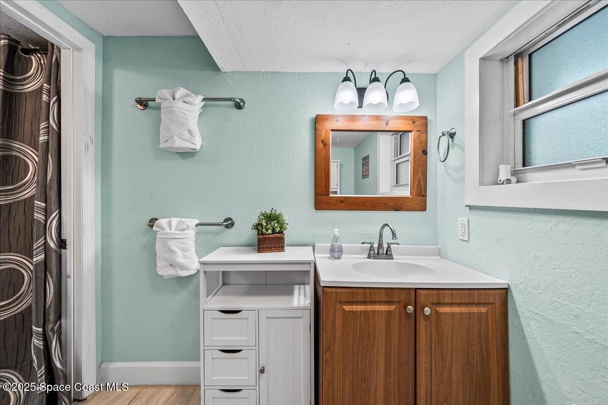 111 South Atlantic Avenue Cocoa Beach, FL 32931 - Photo 27 of 71 a bathroom with a sink mirror and vanity