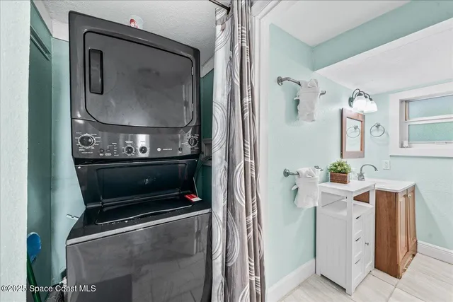 a kitchen with stainless steel appliances granite countertop a stove top oven a sink dishwasher a dining table and chairs with wooden floor