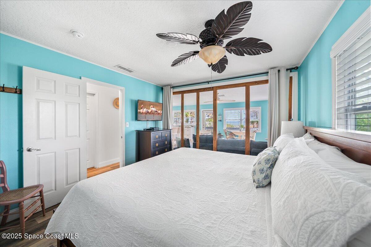 111 South Atlantic Avenue Cocoa Beach, FL 32931 - Photo 44 of 71 a bedroom with a large bed and a large window