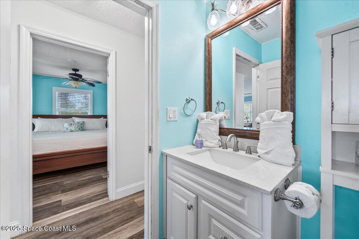 111 South Atlantic Avenue Cocoa Beach, FL 32931 - Photo 45 of 71 a en suite bathroom with a sink and a mirror