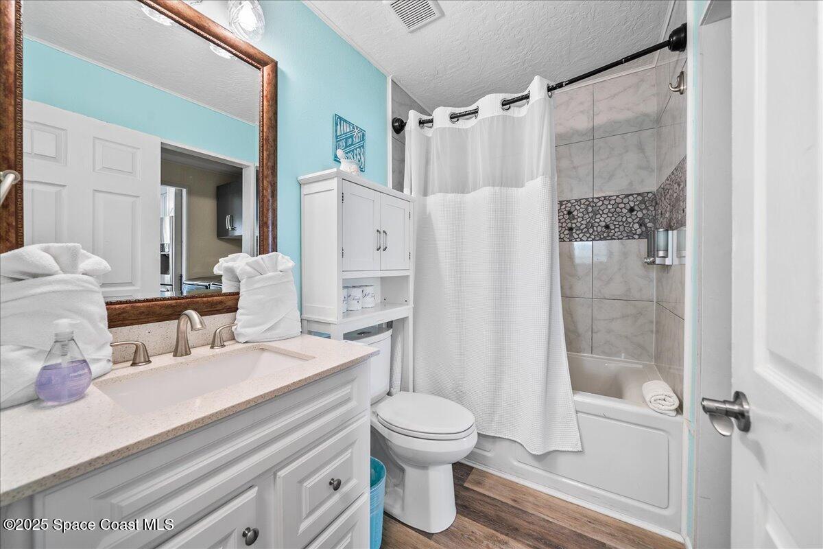 111 South Atlantic Avenue Cocoa Beach, FL 32931 - Photo 46 of 71 a bathroom with a sink toilet and shower