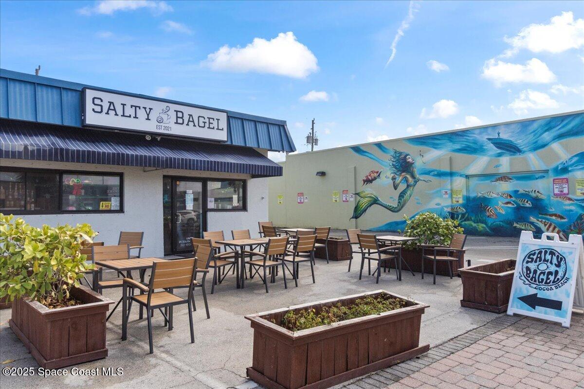 111 South Atlantic Avenue Cocoa Beach, FL 32931 - Photo 64 of 71 a view of a patio with table and chairs