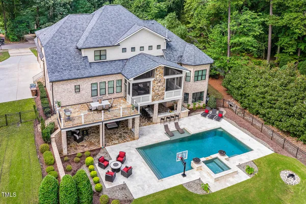 an aerial view of a house with swimming pool garden view and balcony