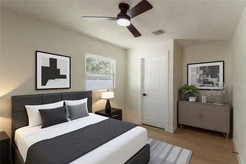 a bedroom with a bed and a painting on the wall