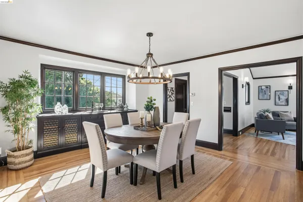 a dining room with furniture window and wooden floor