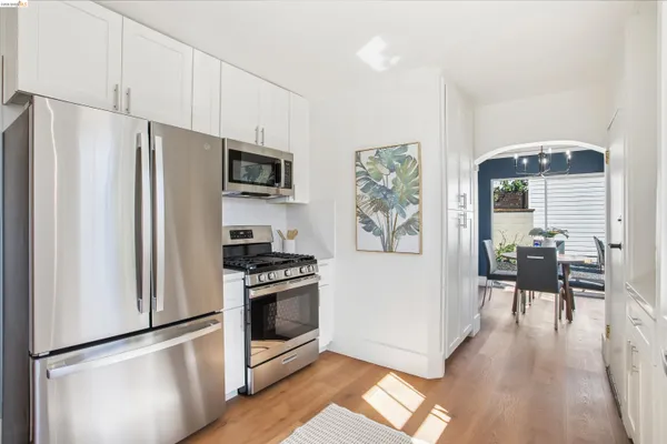 a kitchen with stainless steel appliances a stove a refrigerator and a refrigerator
