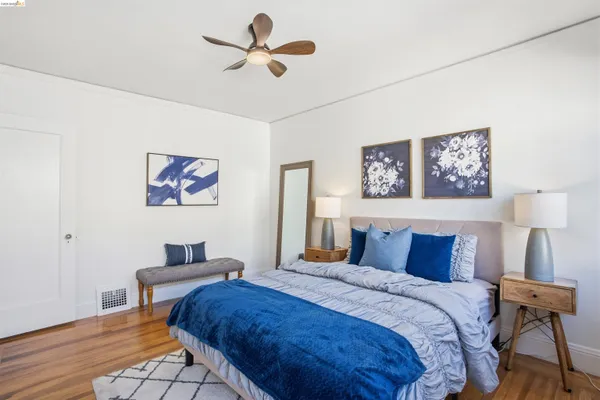 a bedroom with bed and a chandelier