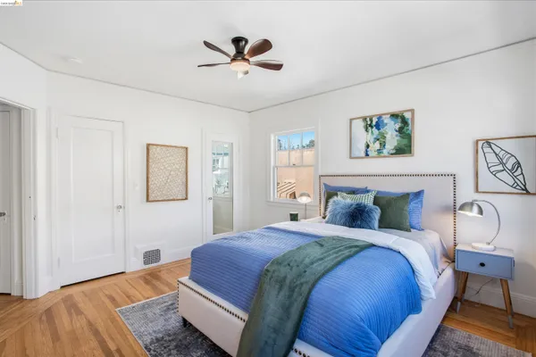 a bedroom with a large bed and a chandelier