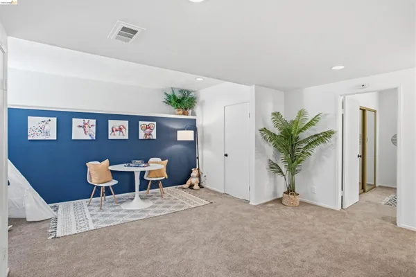 a view of a room with furniture and wooden floor