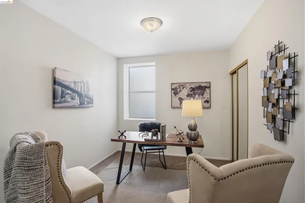 a living room with furniture a rug and a window