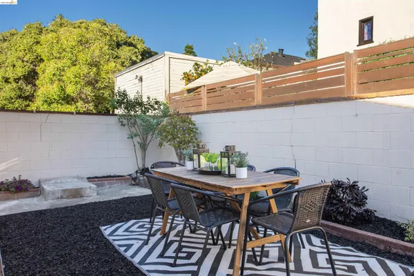 a backyard of a house with table and chairs