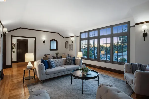 a dining room with furniture window and wooden floor