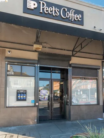 a front view of a building with table and chairs