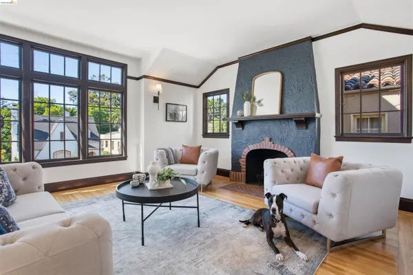 a living room with furniture a fireplace and a large window