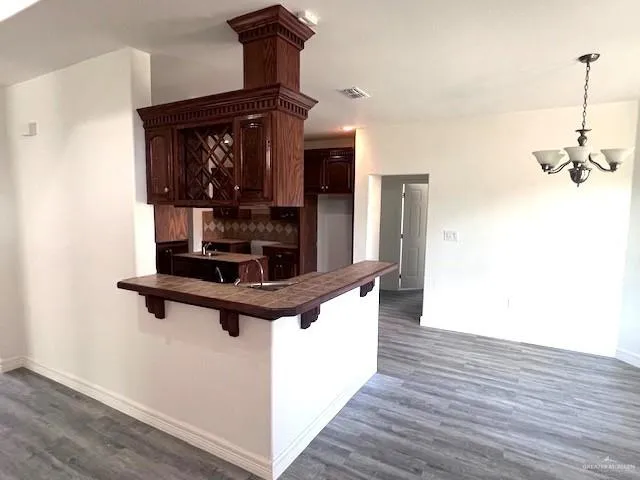 a room with wooden floor a mirror and staircase