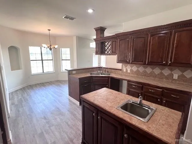 a kitchen with granite countertop a sink and a stove