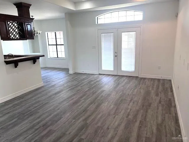 a view of a livingroom with wooden floor and a window