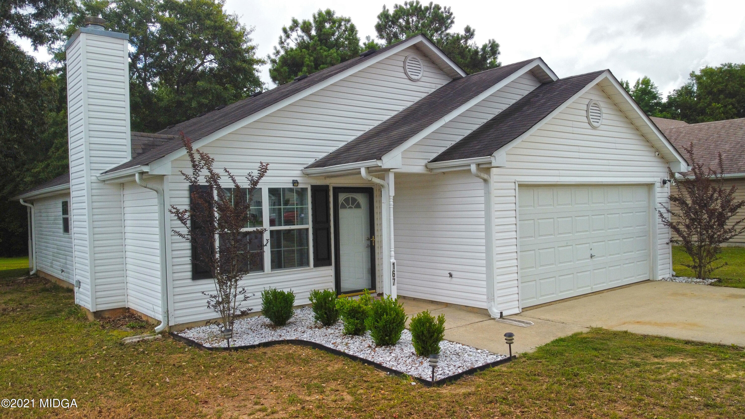 a view of a house with backyard and sitting area