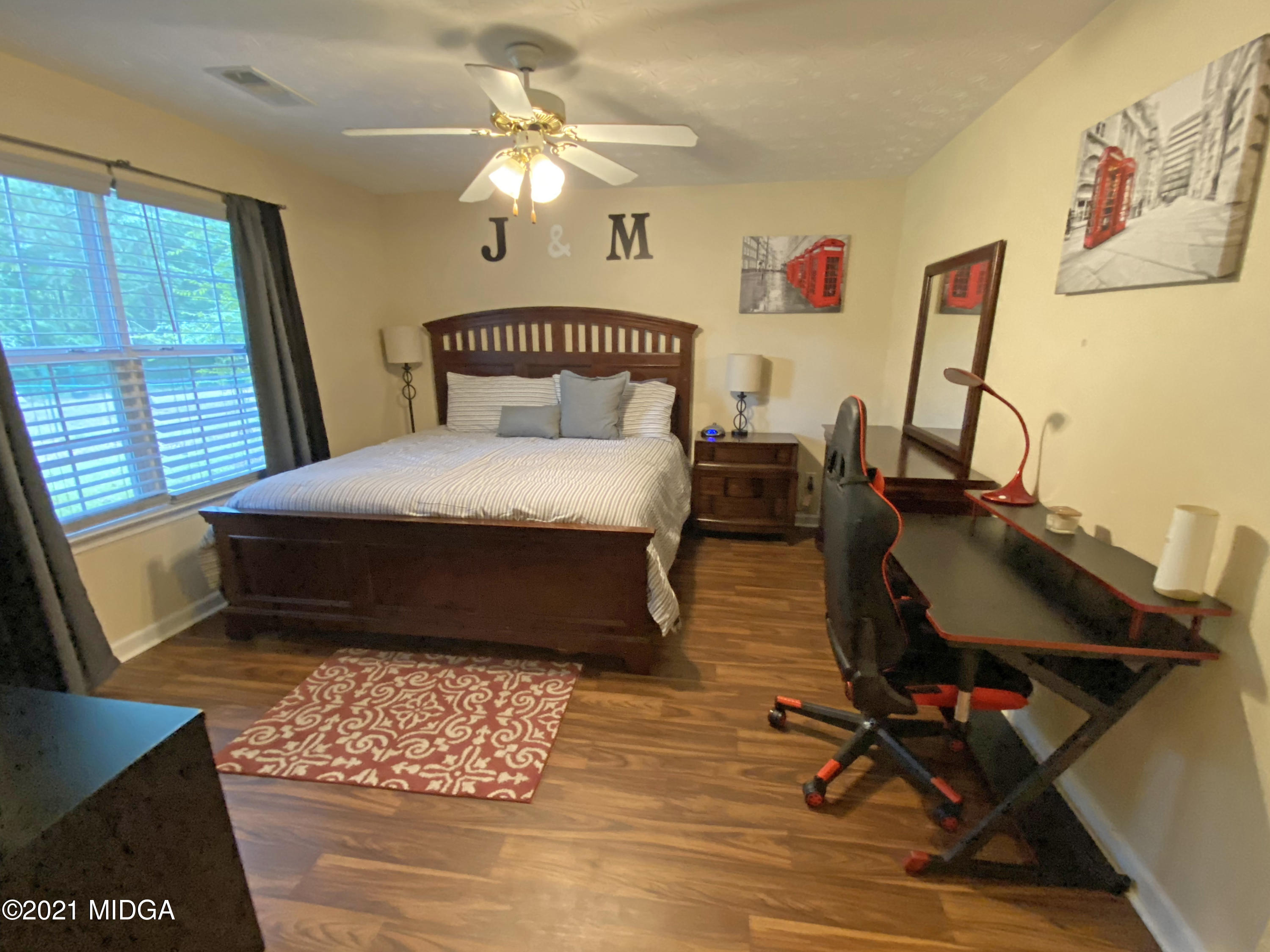167 Apple Valley Road Macon, GA 31217 - Photo 11 of 25 a bedroom with a bed mirror on desk and a window