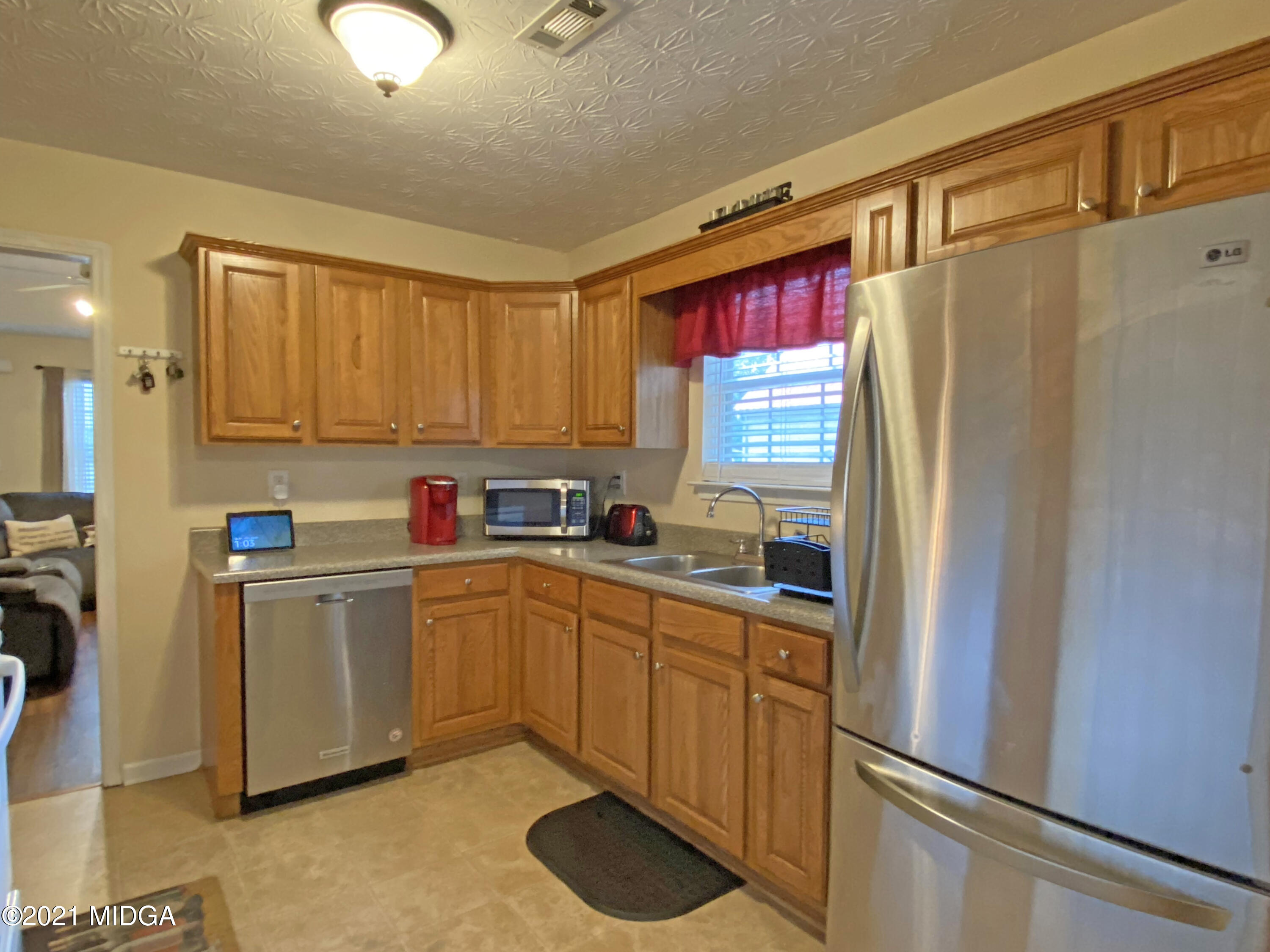 167 Apple Valley Road Macon, GA 31217 - Photo 17 of 25 a kitchen with stainless steel appliances granite countertop a refrigerator sink and white cabinets