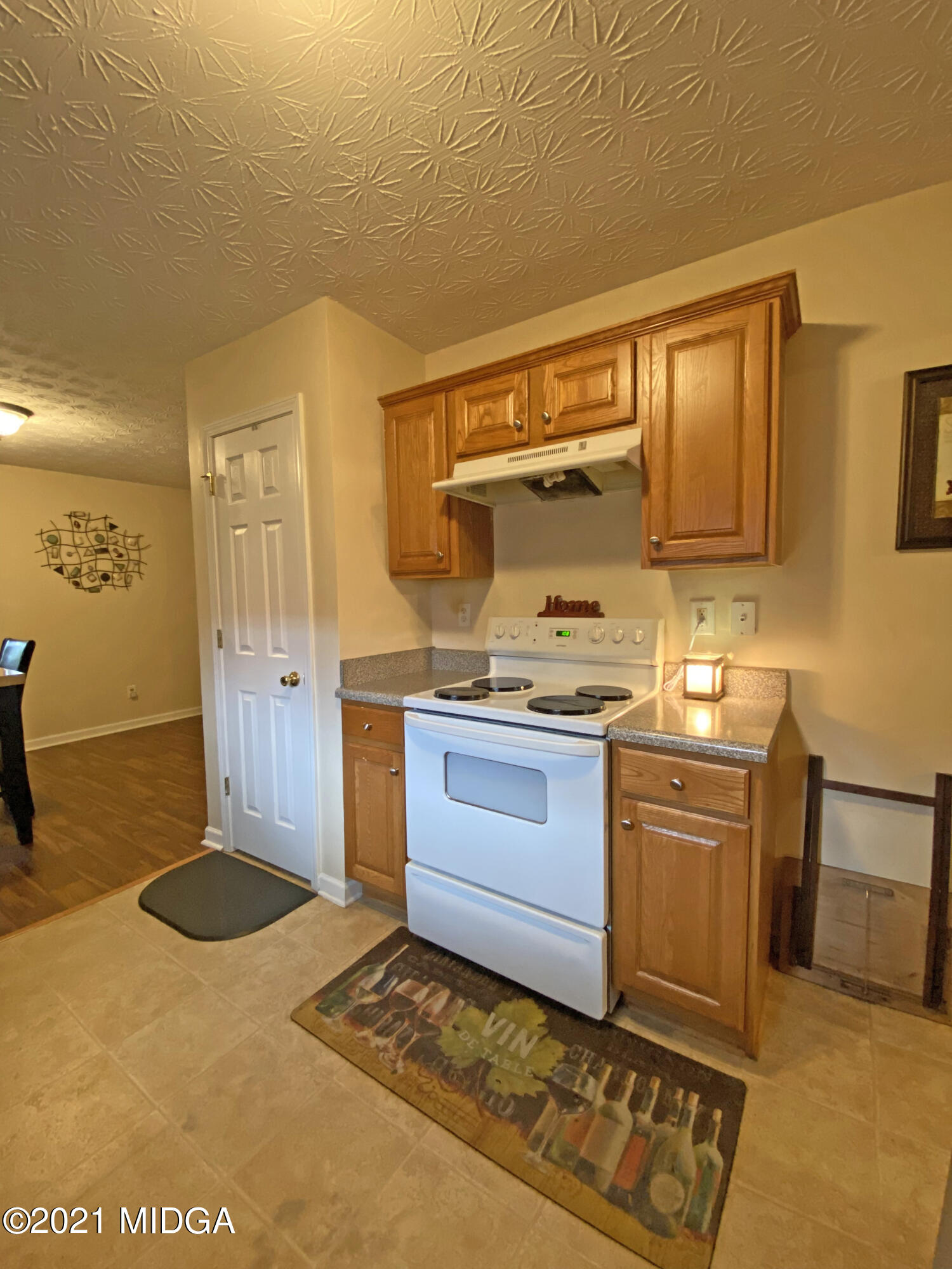 167 Apple Valley Road Macon, GA 31217 - Photo 18 of 25 a kitchen with a stove a sink and a refrigerator