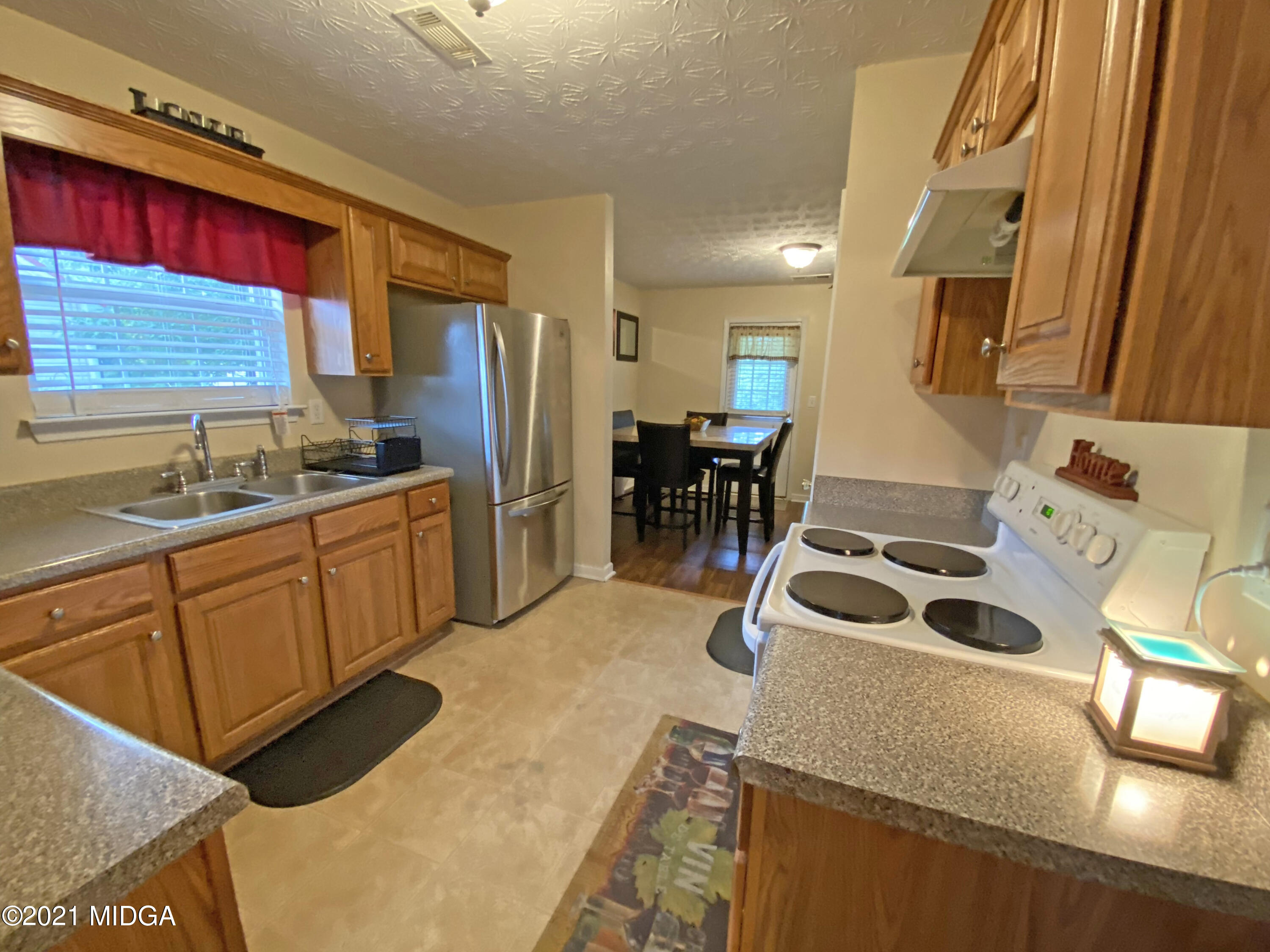 167 Apple Valley Road Macon, GA 31217 - Photo 19 of 25 a kitchen with granite countertop a sink a stove and refrigerator